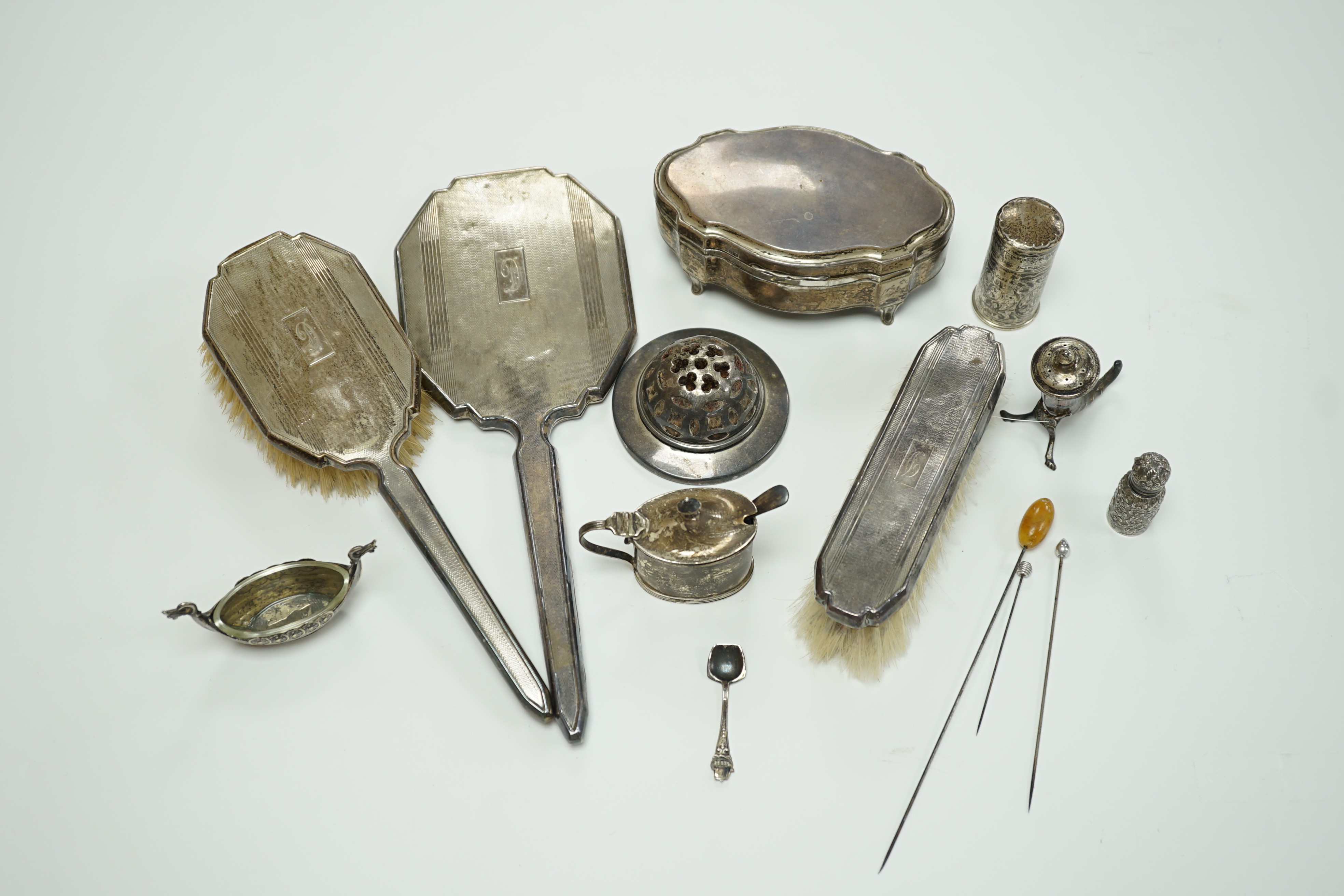 A George V silver mounted trinket box, Elkington & Co, Birmingham, 1918, 13.1cm, a silver mustard pot, two Scandinavian 925 condiments, two silver mounted scent bottles, hatpins and hatpin stand and a silver mounted thre